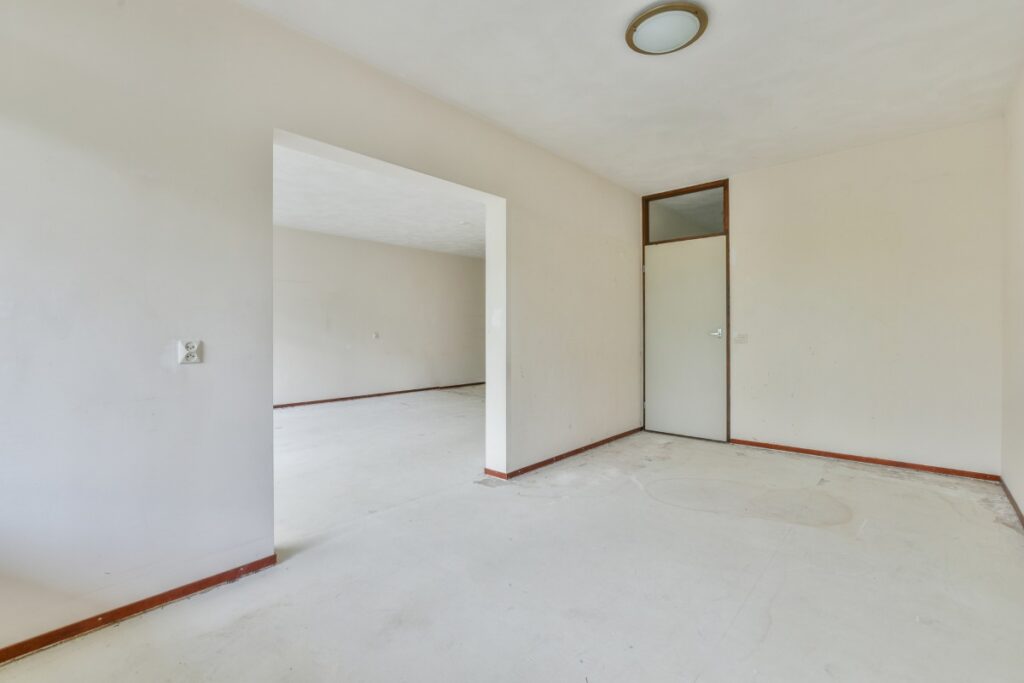 Empty room with white walls and a door