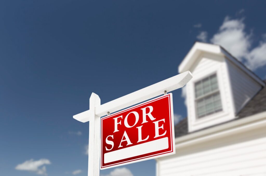 Home For Sale Real Estate Sign in Front of House
