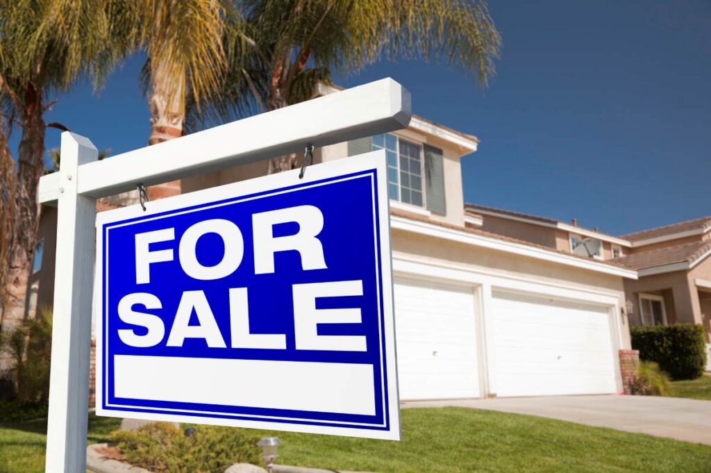 For Sale Real Estate Sign and House