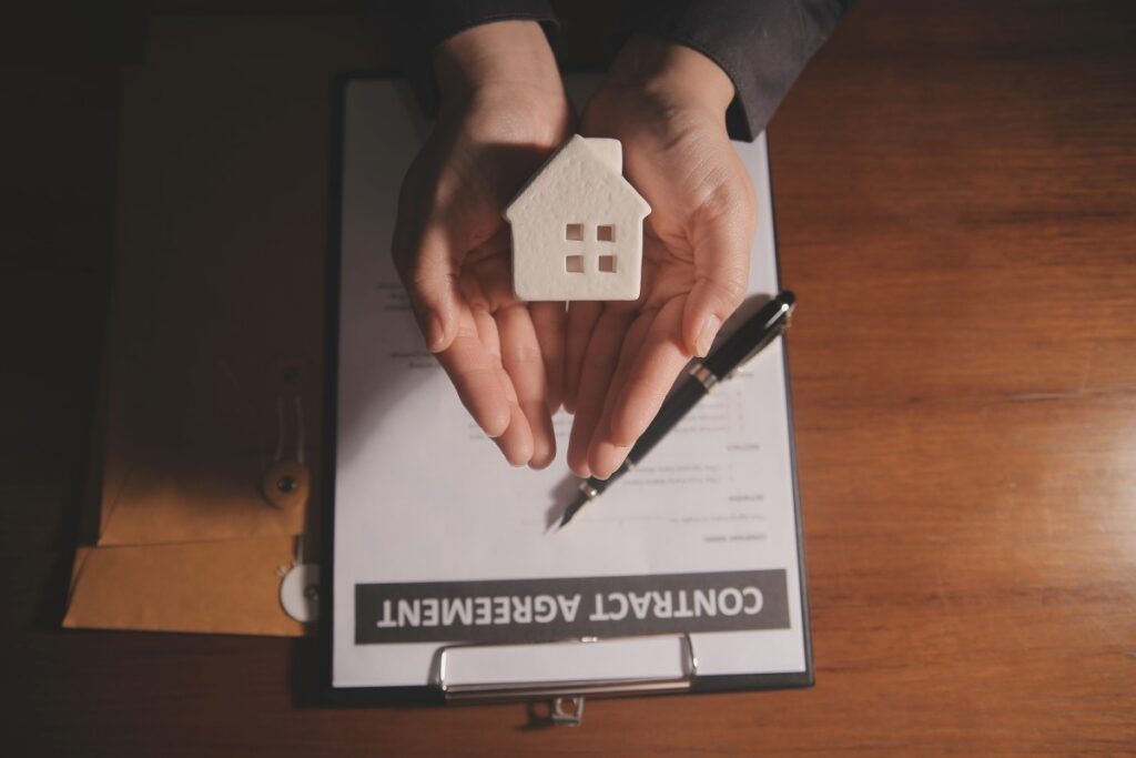 Real estate agent and customer signing contract to buy house, insurance or loan real estate