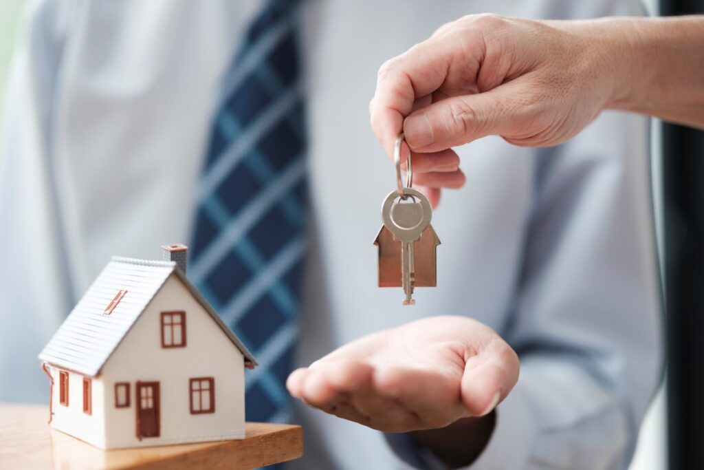 Handing Over House Key for Property Ownership and Real Estate