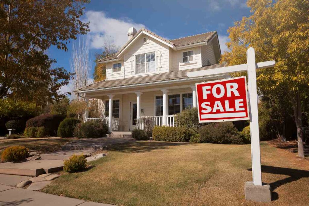 A for sale sign in front of a house
