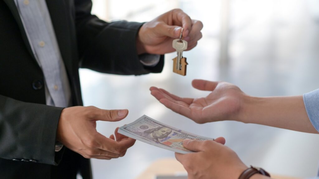 Cropped shot of Exchange of dollars and house keys between buyer and seller