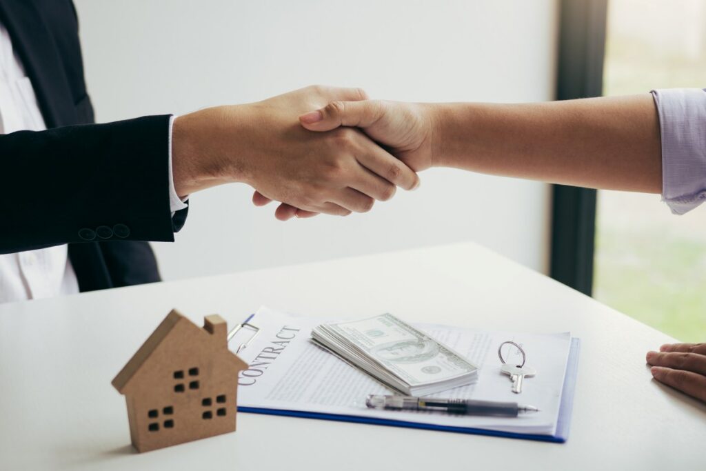 Home sales agents and buyers work on signing new homes and shaking hands