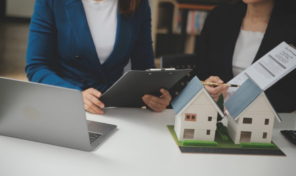 Business Signing a Contract Buy - sell house, insurance agent analyzing about home investment loan Real Estate concept