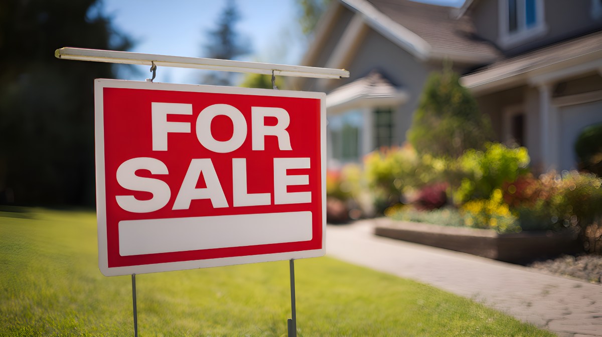 For sale sign announces house is available for purchase