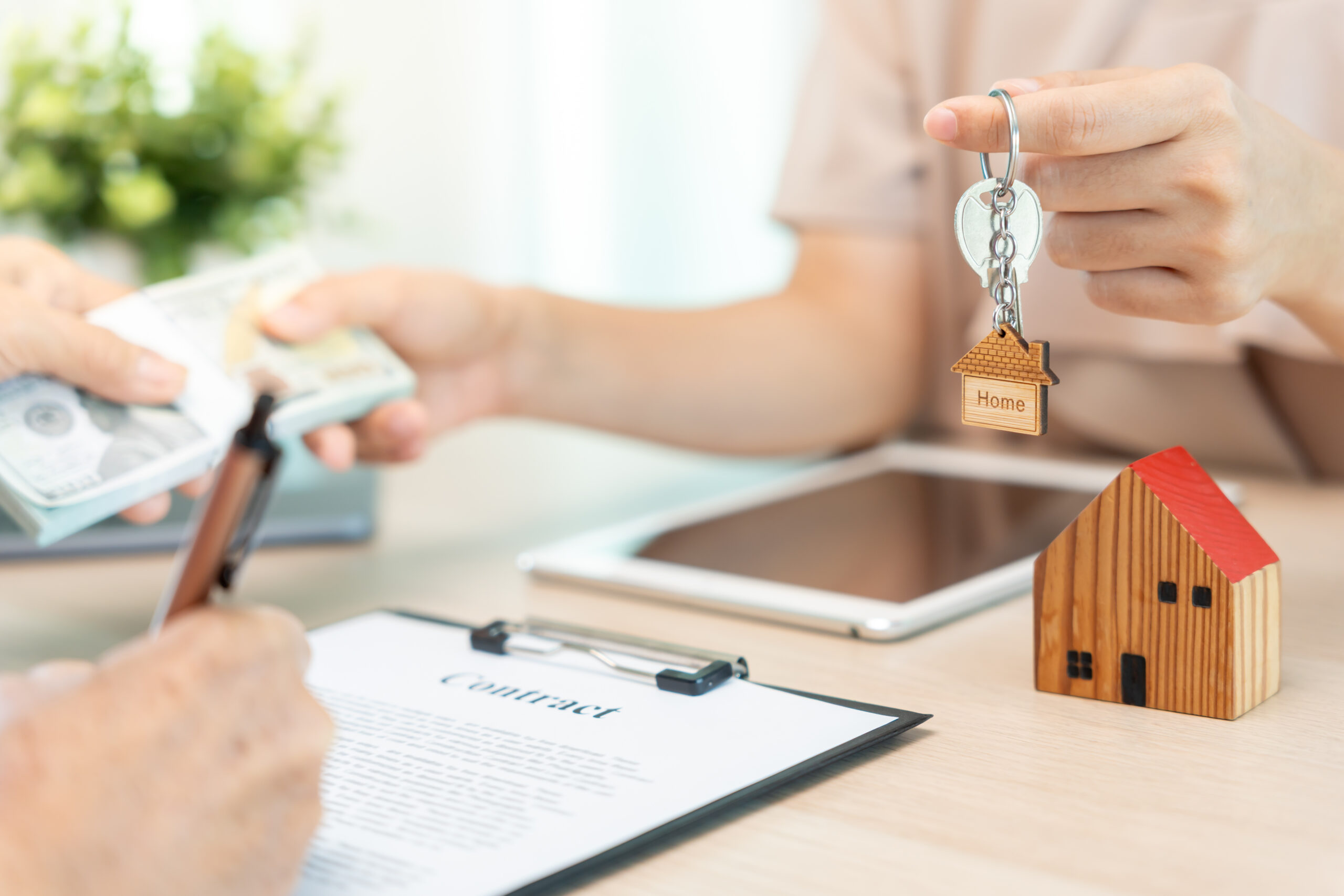 Real estate agent handing over house keys to a client for a lease, rental, or home sale
