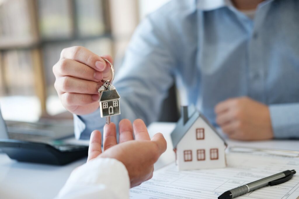 The real estate agent hands the keys to the customer
