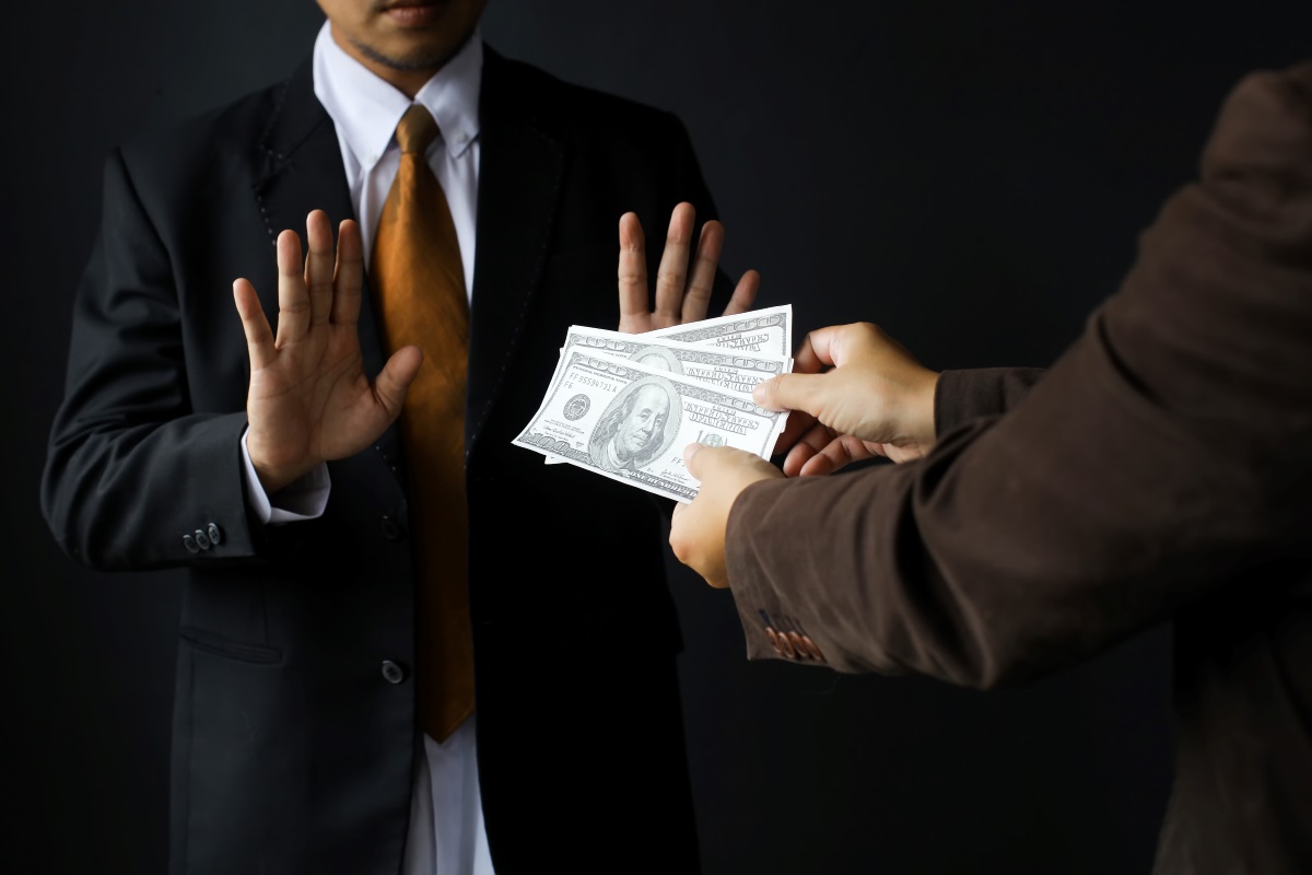 Businessman refusing a bribe, representing corruption and bribery.