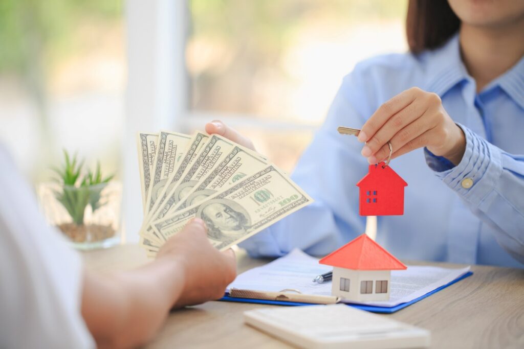 A real estate agent with a key. property insurance, Choosing a house in the future