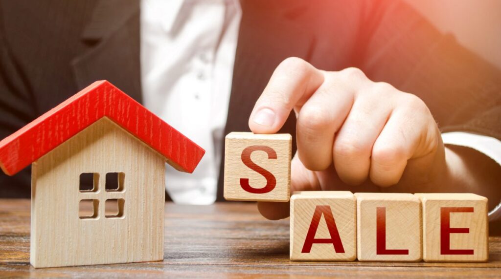 Realtor making word Sale near house. Buying and selling housing. Search for options