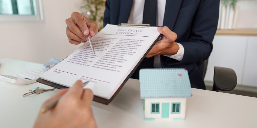 Real Estate Contract Signing. Agent explaining terms to potential buyer