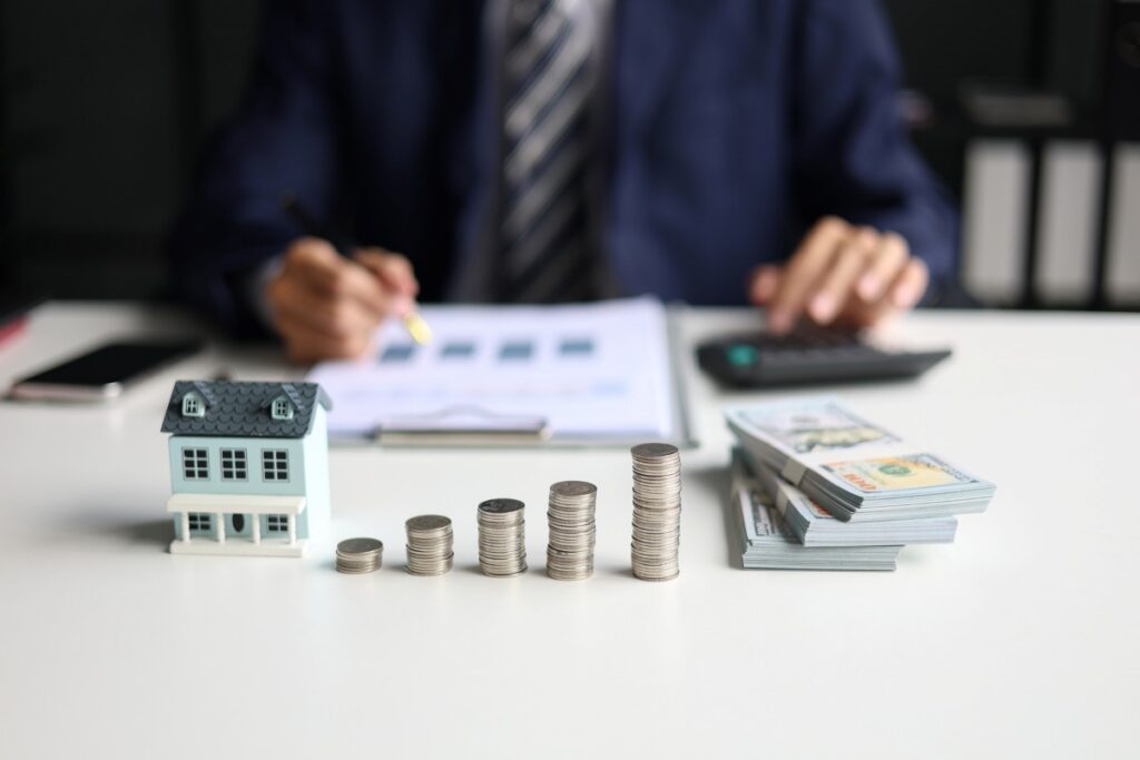 Real estate agent or investor calculating or analyzing financial data related to property investment
