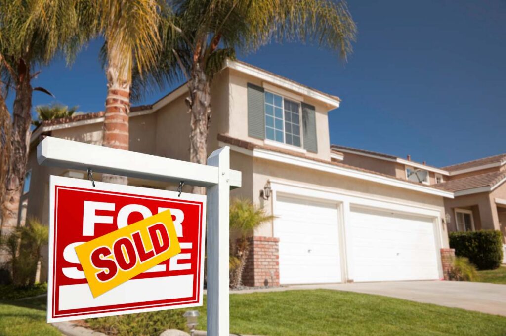 Red Sold For Sale Real Estate Sign and House