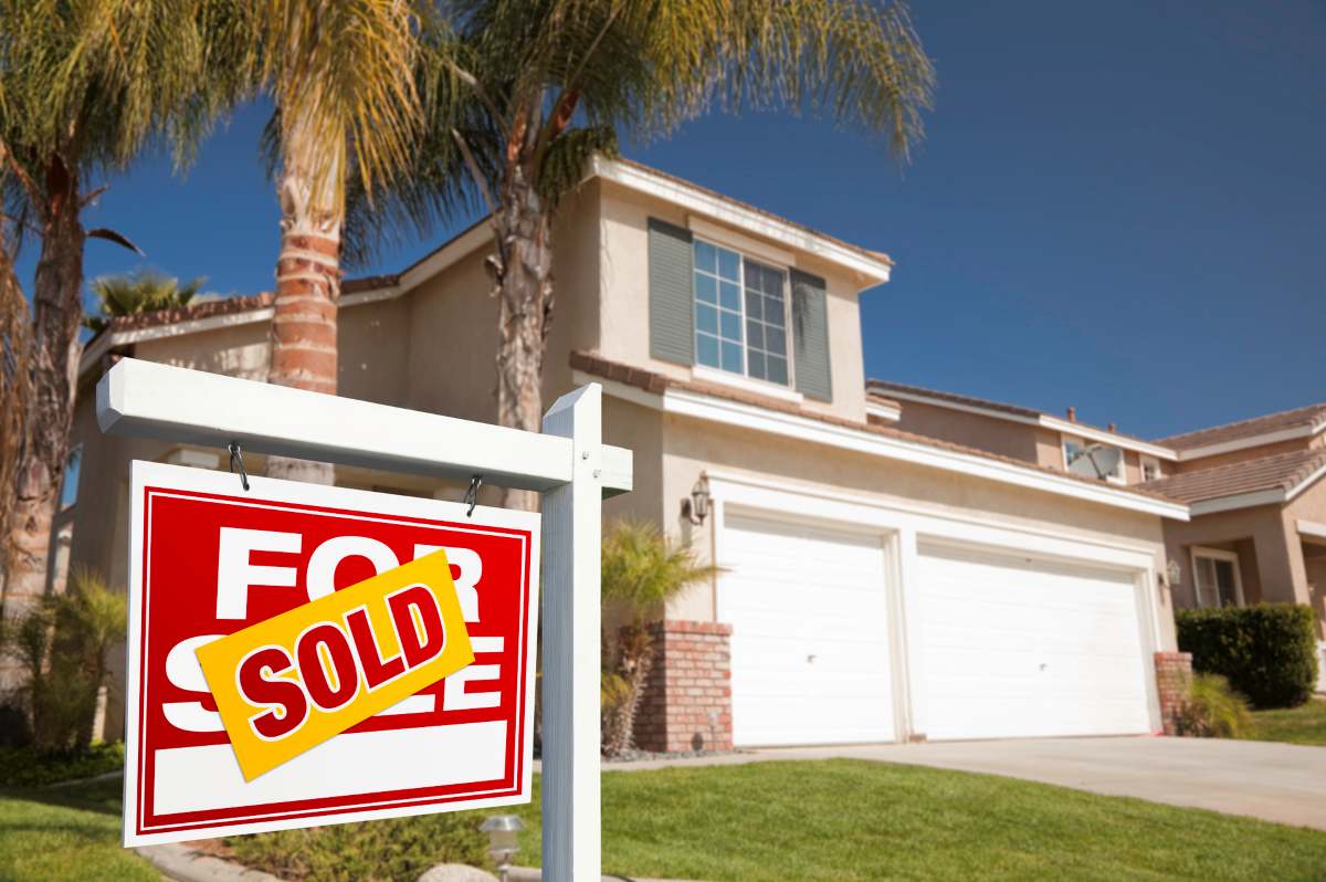 Red Sold For Sale Real Estate Sign and House