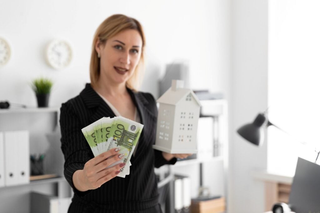 A young girl standing in the office and holding the money and the layout of the house